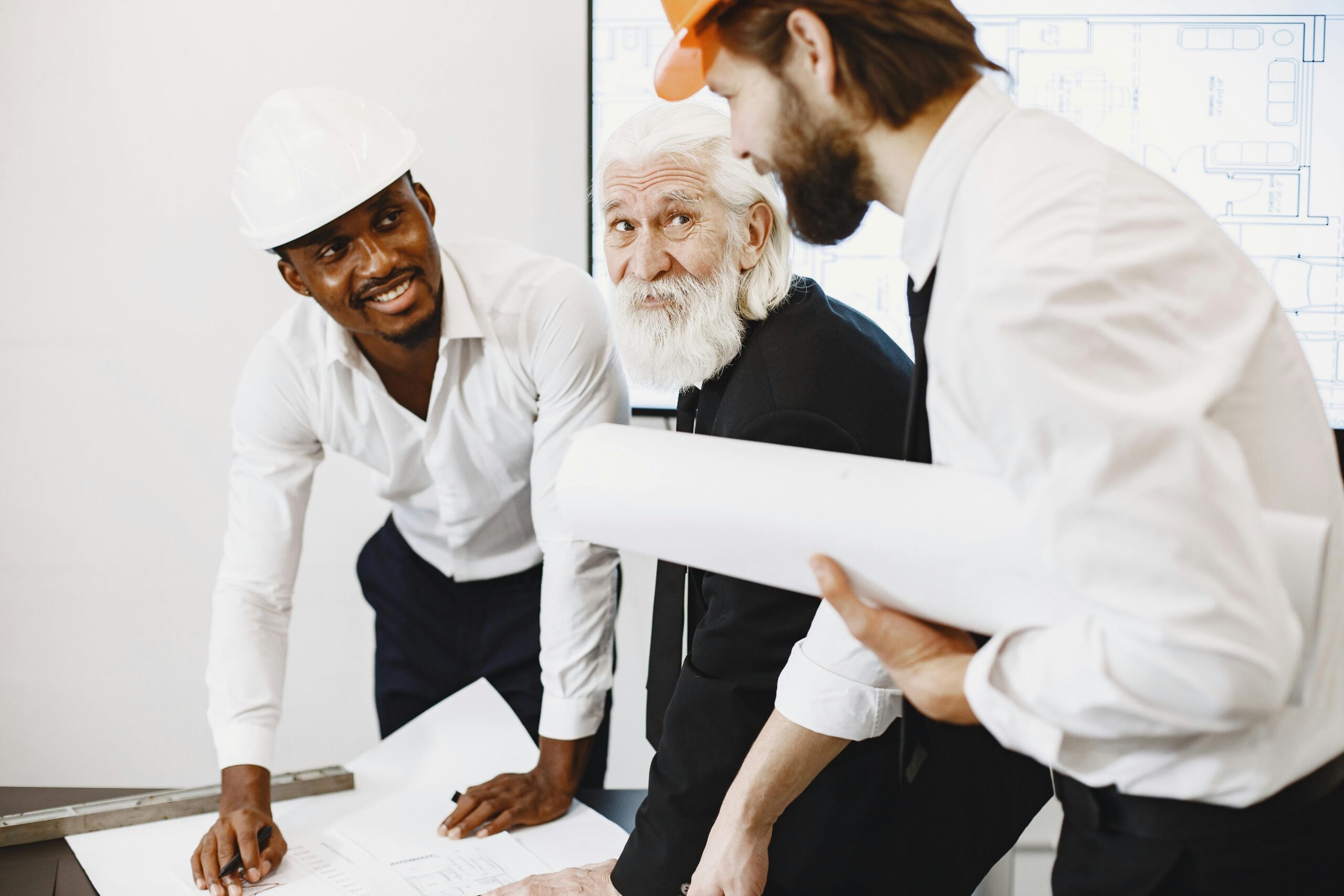 Engineers and architects working together on a construction plan, demonstrating teamwork and professionalism.